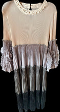 Load image into Gallery viewer, Beige dress with ruffled details on a black background