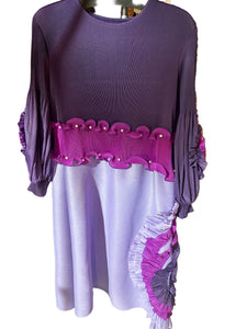 Purple dress with pink trim on a table