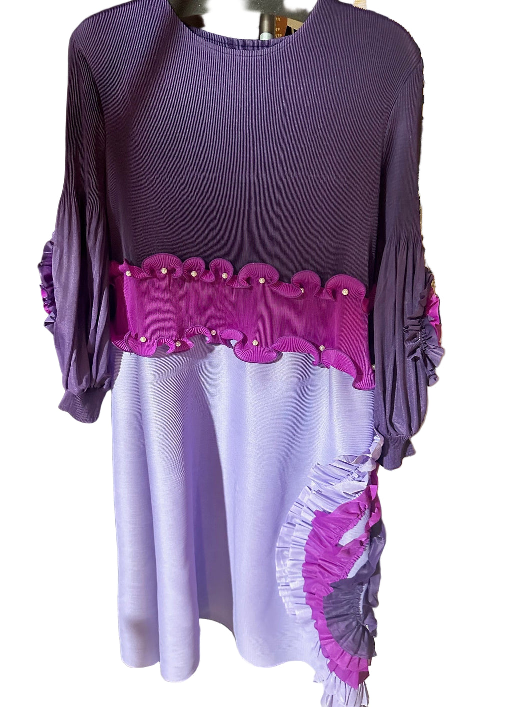 Purple dress with pink trim on a table